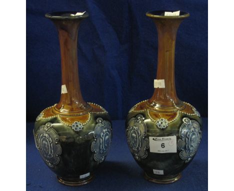 Pair of Royal Doulton stoneware baluster shaped vases with extended necks and portrait panels on graduated green ground.  Pri