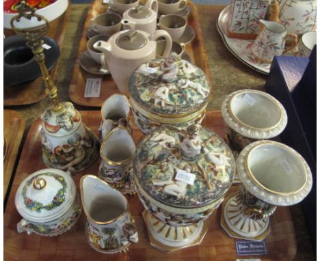 Tray of Cape De Monte items decorated with cherubs etc., to include bell, pair of urn shaped vases, single handled jugs, trin