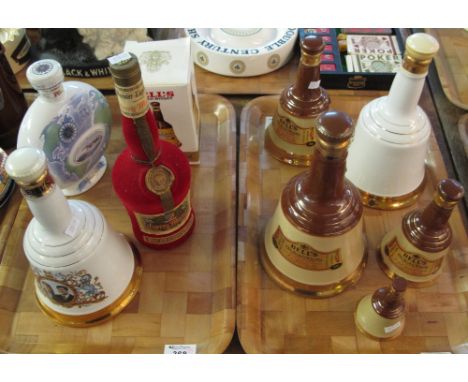 Two tray of mainly Bells scotch whiskey decanters together with a bottle of cherry brandy and a Wade P&O archadia cognac.  (9