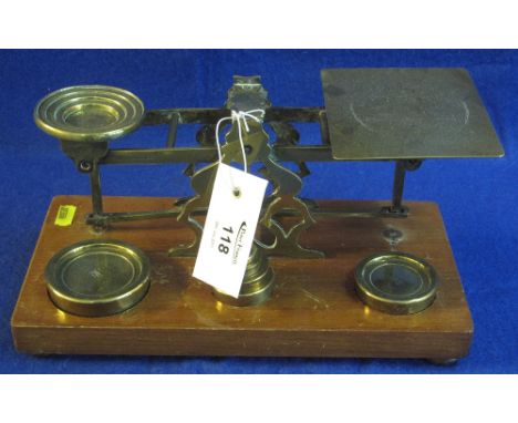 A set of brass letter scales with fitted graduated brass weights by S Mordan & Company, London on wooden base. (B.P. 24% incl