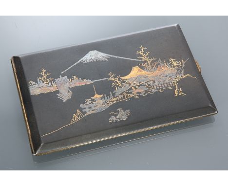 JAPANESE GILT METAL AND 24 CARAT GOLD CIGARETTE CASE
with architectural landscape scene to the cover, 12.5cm wide, in origina