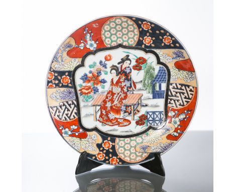 TWO JAPANESE CIRCULAR PLATES
one painted with birds of paradise, the other with a reserve of geisha in a garden setting, 25cm