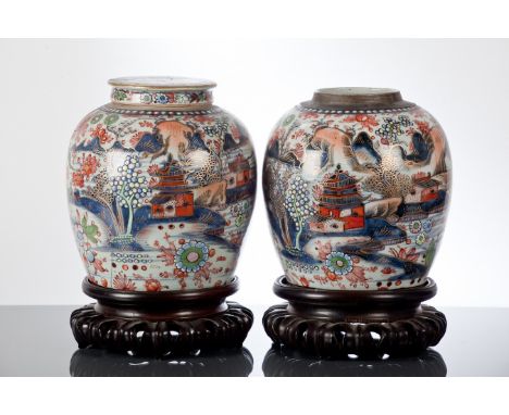 PAIR OF CHINESE GINGER JARS
with floral bird and architectural decoration, each 24cm high, one with lid lacking, each on wood