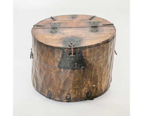 KOREAN RICE BOX 
carved from a tree trunk, of oval form and with metal mounts, 53.5cm wide, 43cm high 