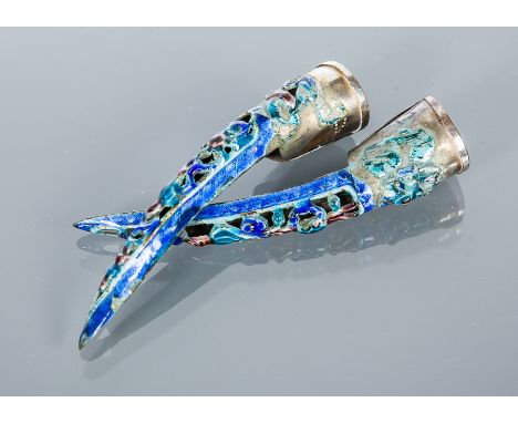 TWO EARLY 20TH CENTURY CHINESE WHITE METAL AND ENAMEL NAIL GUARDS
with fine cloisonne scrolling leaves and floral designs in 