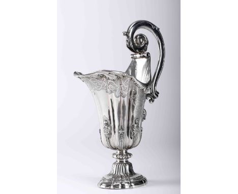 An helmet-shaped ewerAn helmet-shaped ewer, D. João V (King of Portugal) style,, silver, wavy decoration with chiseled frieze