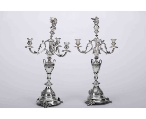 A pair of four-light candelabraA pair of four-light candelabra, 950/1000 silver, chiseled decoration in relief "Lion's Fauces