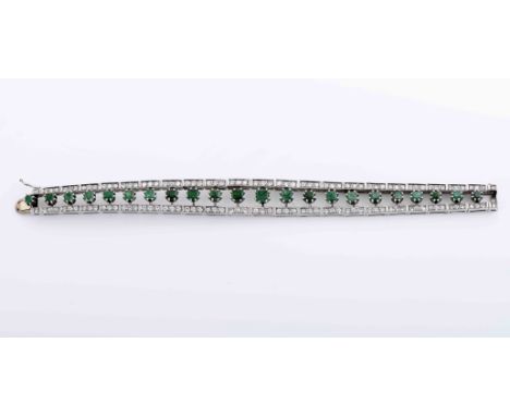 A braceletA bracelet, platinum and gold, set with 22 emeralds and 130 brilliant cut diamonds with the approximate weight of 3