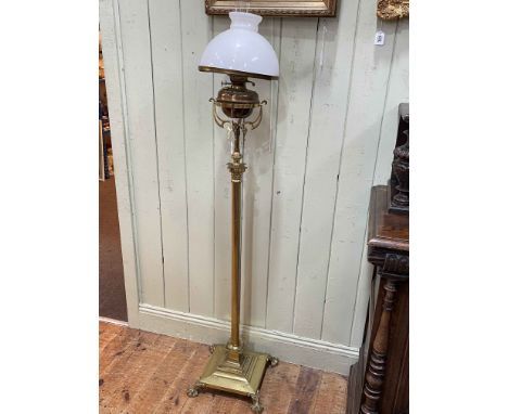 Brass corinthian column standard oil lamp on paw feet.