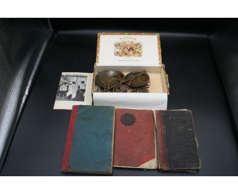 A cigar box with scales and part set of weights. Together with 3 hand written books, one on costs, one on design and a trade 