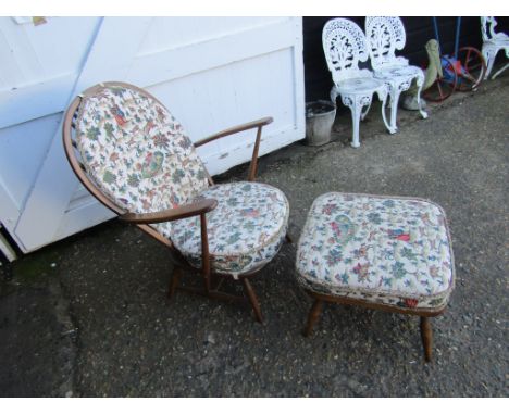 Upholstered Ercol stick back armchair and footstool with hunting themed pattern fabric