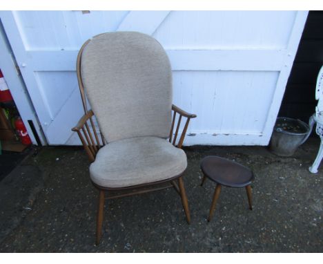 Upholstered Ercol stick back armchair and stool&nbsp;