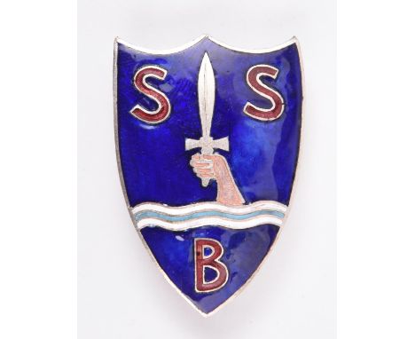 A beret badge of the Special Boat Section/Service,  of white metal with blue and red enamel and two lugs for vertical pin. VG