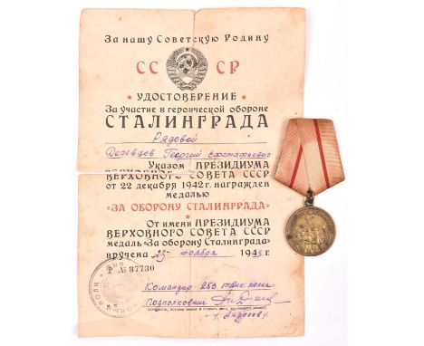 A WWII Soviet Russian medal for the Defence of Stalingrad, first type issued during the war, with ribbon and pin, together wi