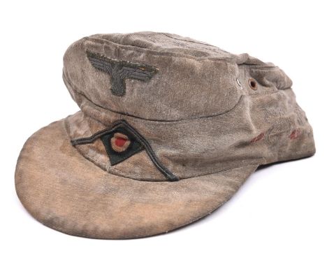 A Third Reich Army OR’s peaked feldmutze, embroidered with service details etc. unofficially. GC (some wear)  £220-250. 