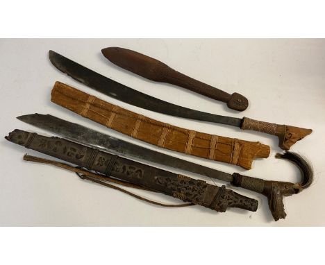 TWO SIMILAR BORNEO DYACK HEAD HUNTERS SWORDS AND A CLUB. A Dyack 'Head Hunters' sword with a 54cm shaped and engraved blade w