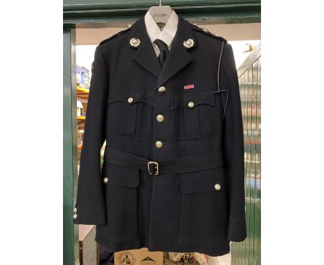 A ROYAL MARINES 'BLUES' UNIFORM. A uniform by Rogers John Jones Ltd of Mayfair, the label named 'Lt C.J. Goode, the jacket wi