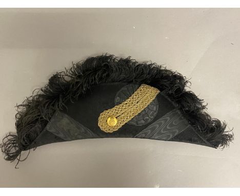 A FOLDING BLACK SILK AND BRAID ROYAL NAVY STYLE BICORN HAT. The folding hat with an elaborate black feather plume, the side w