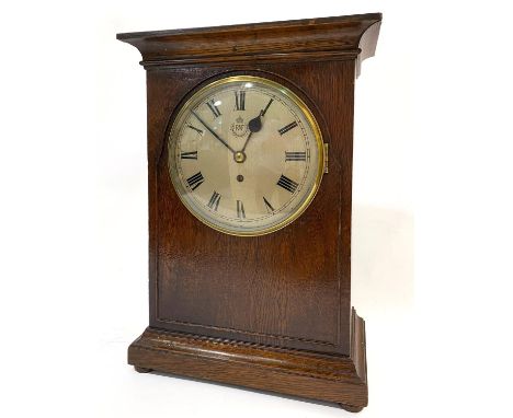 A LARGE R.A.F. MANTEL CLOCK. A large oak cased mantel clock with 20cm domed and silvered dial with Roman numerals, with a sin