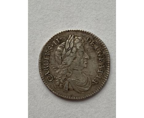 A CHARLES II SIXPENCE. A Charles II Sixpence dated 1683, draped bust r. conjoined 'C's in angles.