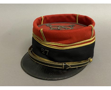 A MID 20TH CENTURY FRENCH INFANTRY OFFICERS KEPI, 27TH INFANTRY REGIMENT. A Kepi cap with red fabric top with interlaced gold