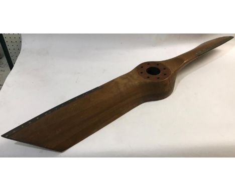 A GIPSY THREE PROPELLOR BOSS. A laminated mahogany propeller for aa Gypsy III engine with brass mounted leading edges. Stampe