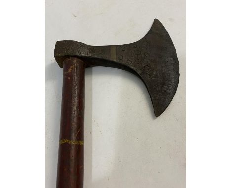A TRIBAL AXE WITH LONG PAINTED HANDLE. The axe head with a rounded cutting edge and impressed star decoration, on a long pain