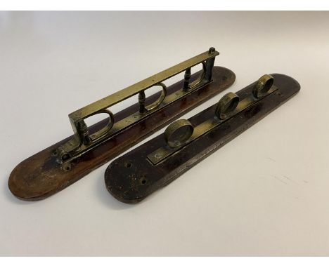 A LATE 18TH/EARLY 19TH CENTURY MUSKET RACK. A two part wall mounting musket rack with brass fittings, on end with three ring 