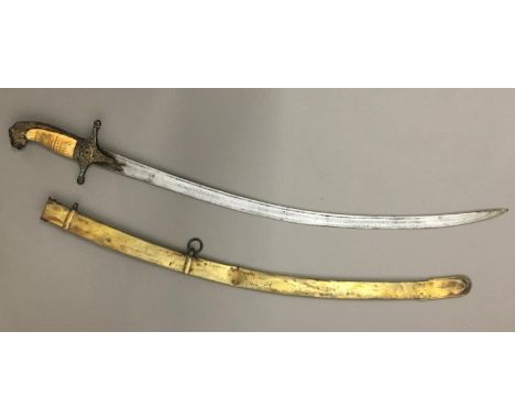 A 19TH CENTURY TURKISH MAMELUKE SWORD AND SCABBARD. The 67cm curved and fullered blade with a sharpened edge and engraved Tur