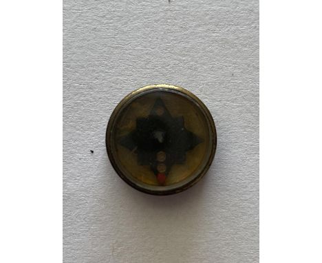 A SECOND WORLD WAR BUTTON COMPASS. A small brass cased compass, possibly M19 SOE issue. 15mm wide.