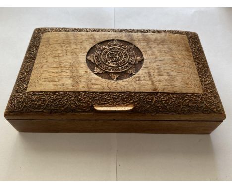 A GEROGE VI R.A.S.C. CARVED WOODEN BOX. A rectangular teak cigarette box with domed lid carved with a George VI Royal Army Se