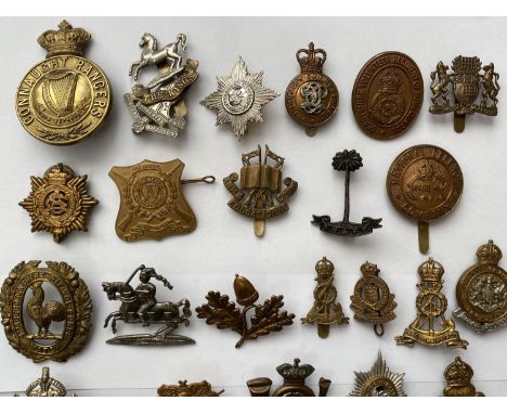 A COLLECTION OF REGIMENTAL CAP BADGES. A collection of thirty cap badges to include examples for the Army Education Corps, De