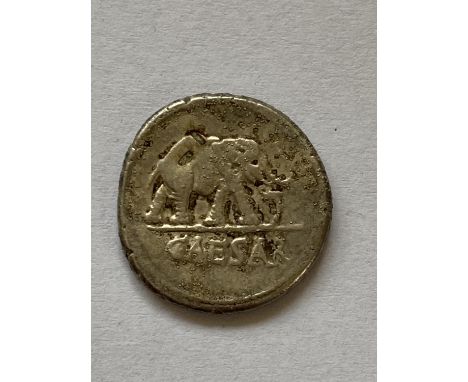 A JULIUS CAESAR ROMAN IMPERIAL SILVER DENARIUS. Obverse elephant r. above Caesar, reverse with scattered implements, possibly