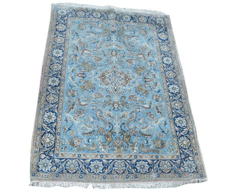 Part silk Tabriz rug, decorated with beasts, birds and floral scrolls, on light blue ground, 203 x 135cms.