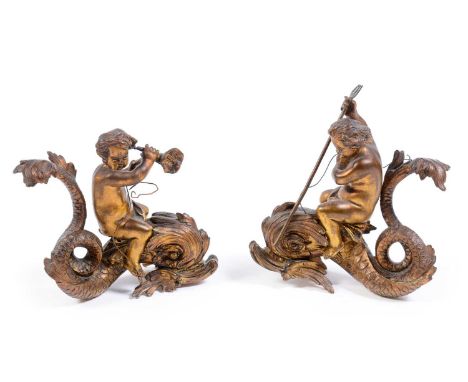 A pair of 19th Century ormolu figurines of cherubs riding dolphins, one holding a trident, the other a cornucopia, 14cms.