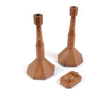 A pair of Robert "Mouseman" Thompson carved oak candlesticks and an ashtray, the candlesticks of octagonal section with trade