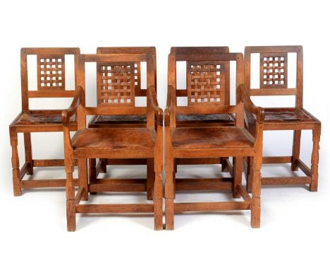A set of six mid 20th Century Robert 'Mouseman' Thompson oak dining chairs, including two carvers, each with square backs and