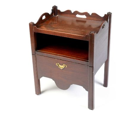 A George III mahogany tray top nightstand, with shaped and pierced three-quarter gallery, above an open recess and shaped pul