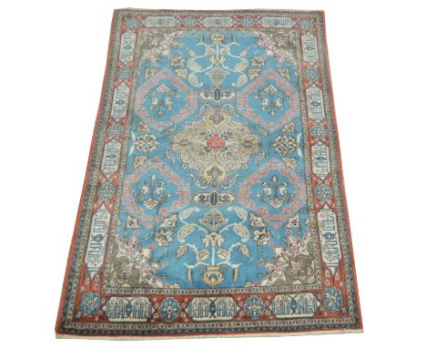 Antique Qum carpet, with bold floral decoration on light blue ground, 215 x 136cms.