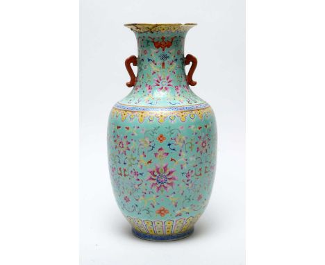 A Chinese famille rose vase, Qianlong seal mark, with waisted neck and ovoid body, decorated with stylised chrysanthemums, ba