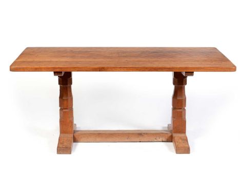 A mid 20th Century Robert 'Mouseman' Thompson oak dining table, the rectangular adzed top, raised on octagonal baluster legs 