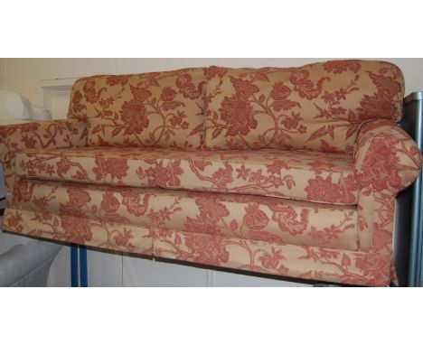 A modern floral upholstered three seater sofa