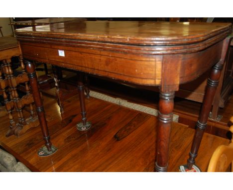 An early 19th century mahogany and ebony inlaid round cornered fold-over card table 