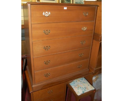 A Stag bedroom suite comprising; mirror back twin pedestal dressing table with stool, five drawer chest, and a pair of single