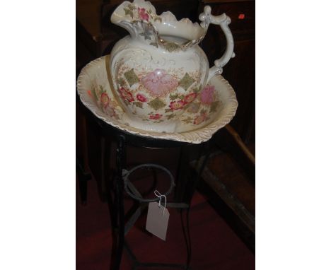 A Victorian black painted wrought metal washstand, having associated ceramic jug and bowl 