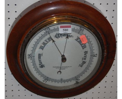 An early 20th century walnut circular aneroid barometer by Pastorelli & Rapkin Ltd of London