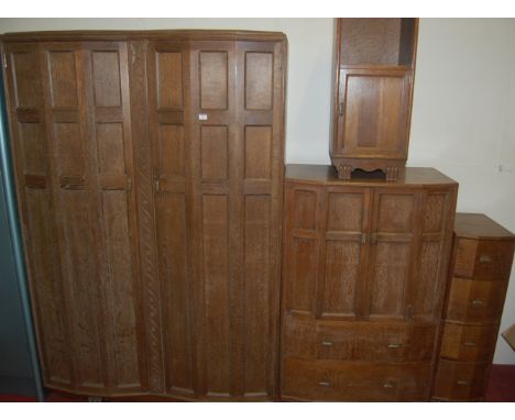 An Art Deco limed oak three piece bedroom suite, comprising; double door wardrobe, twin door tallboy compactum over two long 