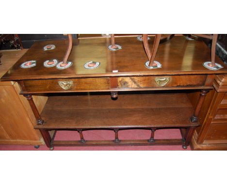 A Liberty & Co Arts & Crafts walnut two-tier buffet, having twin short drawers, raised on part turned and square cut supports