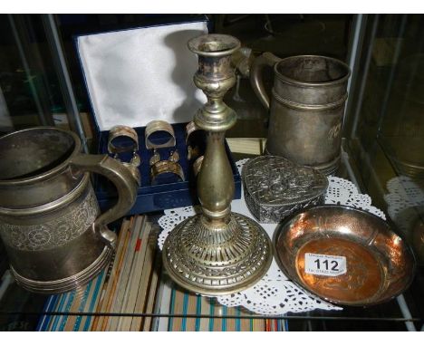 A mixed lot including napkin rings, tankards, candlestick etc.,