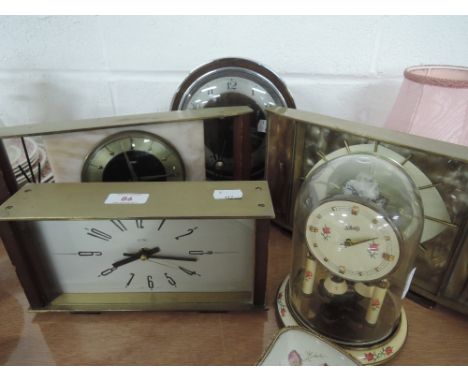 Four Metmec mantle clocks and a Schatz anniversary clock 
